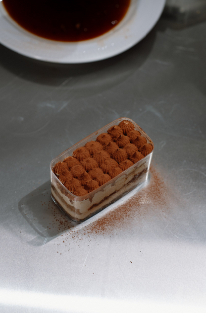 300ml Cocoa-dusted Tiramisu on a table
