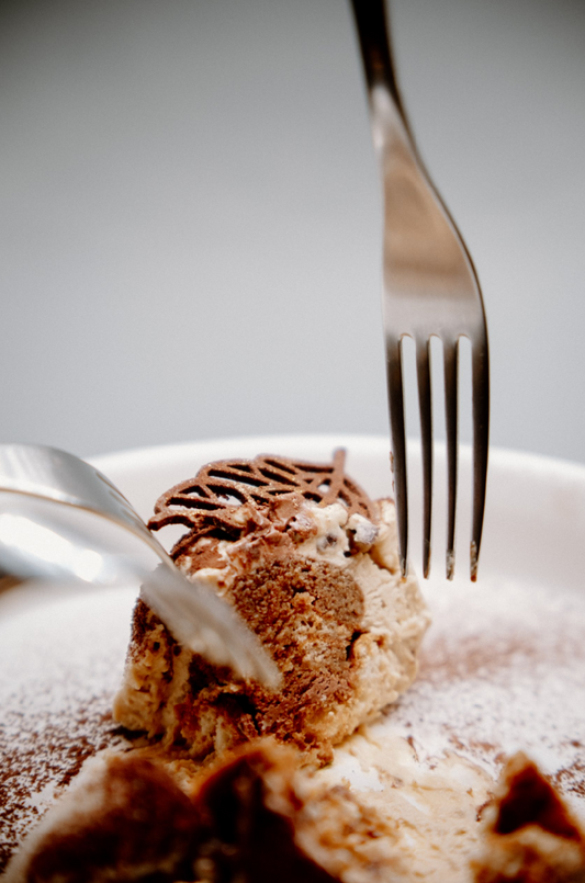 Close-up of a dessert with a fork on a white plate